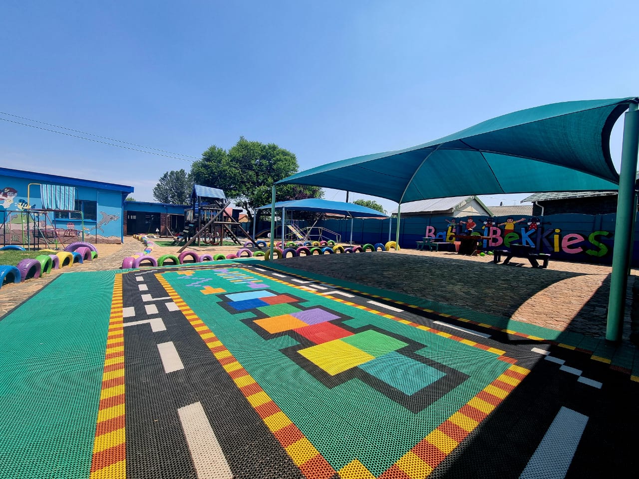 A colourful path and shaded play area
